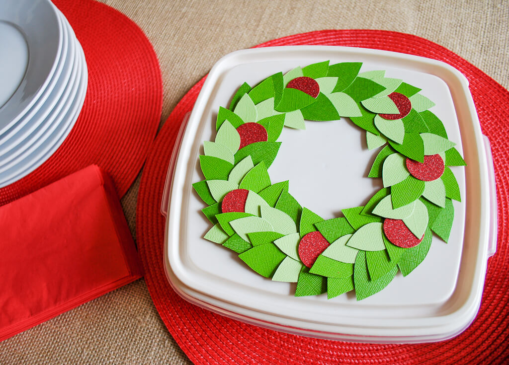 Decorate tupperware storage containers with a wreath for holiday cookie exchanges - it removes easily to wash and re-use next year. #tupperware #velcrobrand #spon #handmadewithjoann #christmas #cookies #christmascookies #wreath #papercrafts #christmaswreath