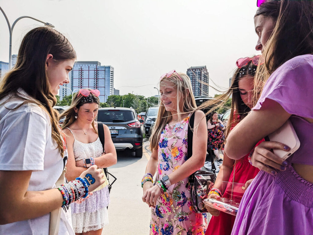 Trading bracelets at the Taylor Swift Concert at Soldier Field. Copyright 2023 Merriment Design Co. Please contact me for written permission before sharing this photo.