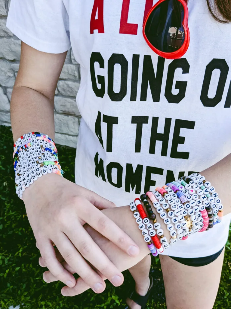 DIY Taylor Swift friendship bracelets on arms with a Taylor Swift A Lot Going On At The Moment shirt