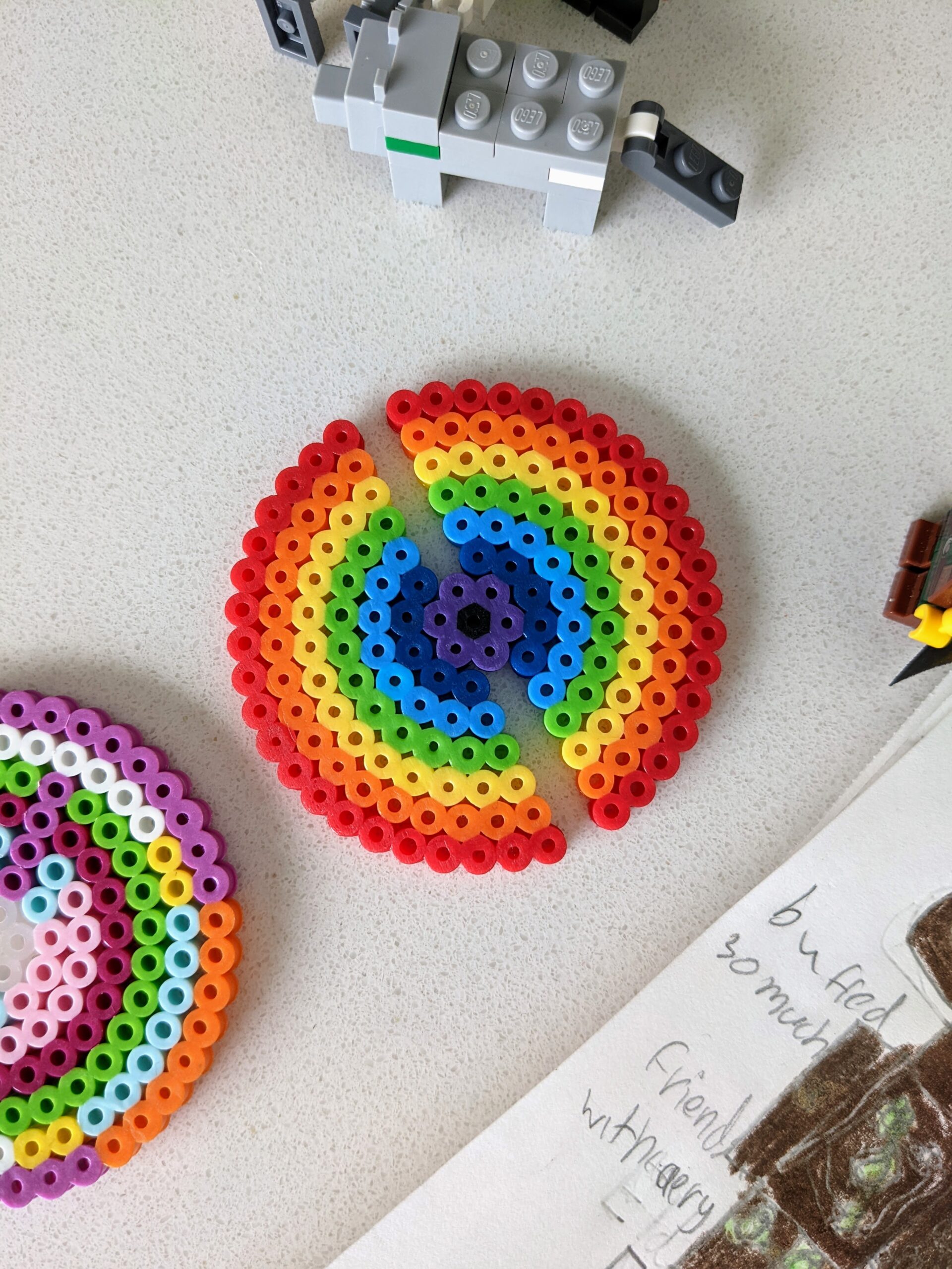 Perler beads in a rainbow circle pattern