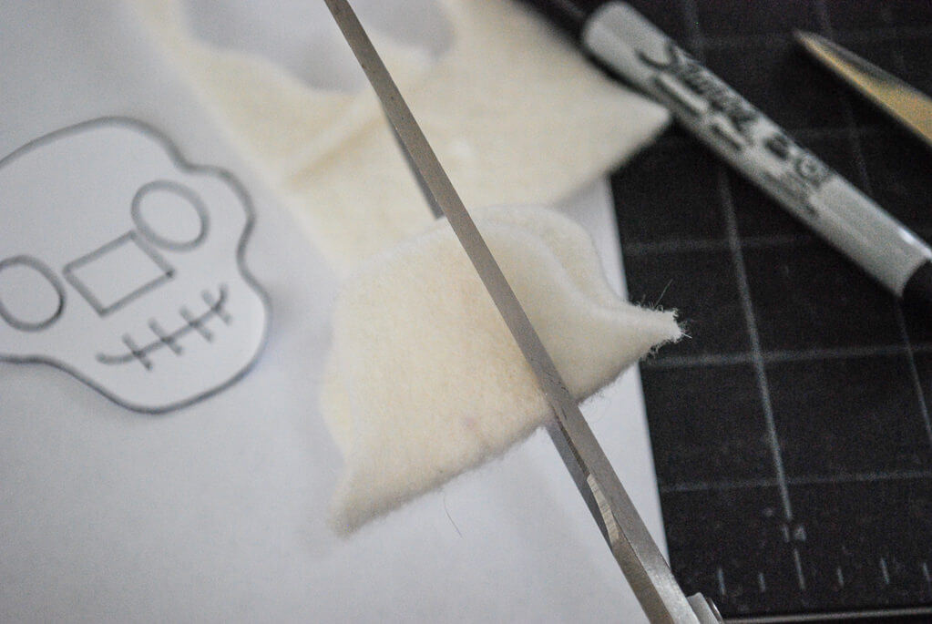 Cutting slits in DIY felt Halloween skeleton bracelets