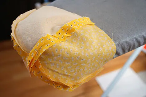 Ironing a baby bonnet hat crown