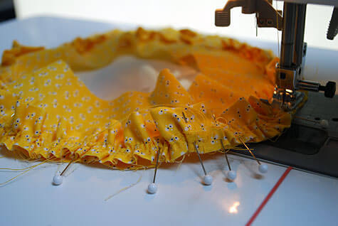 Sewing a ruffle on a baby hat