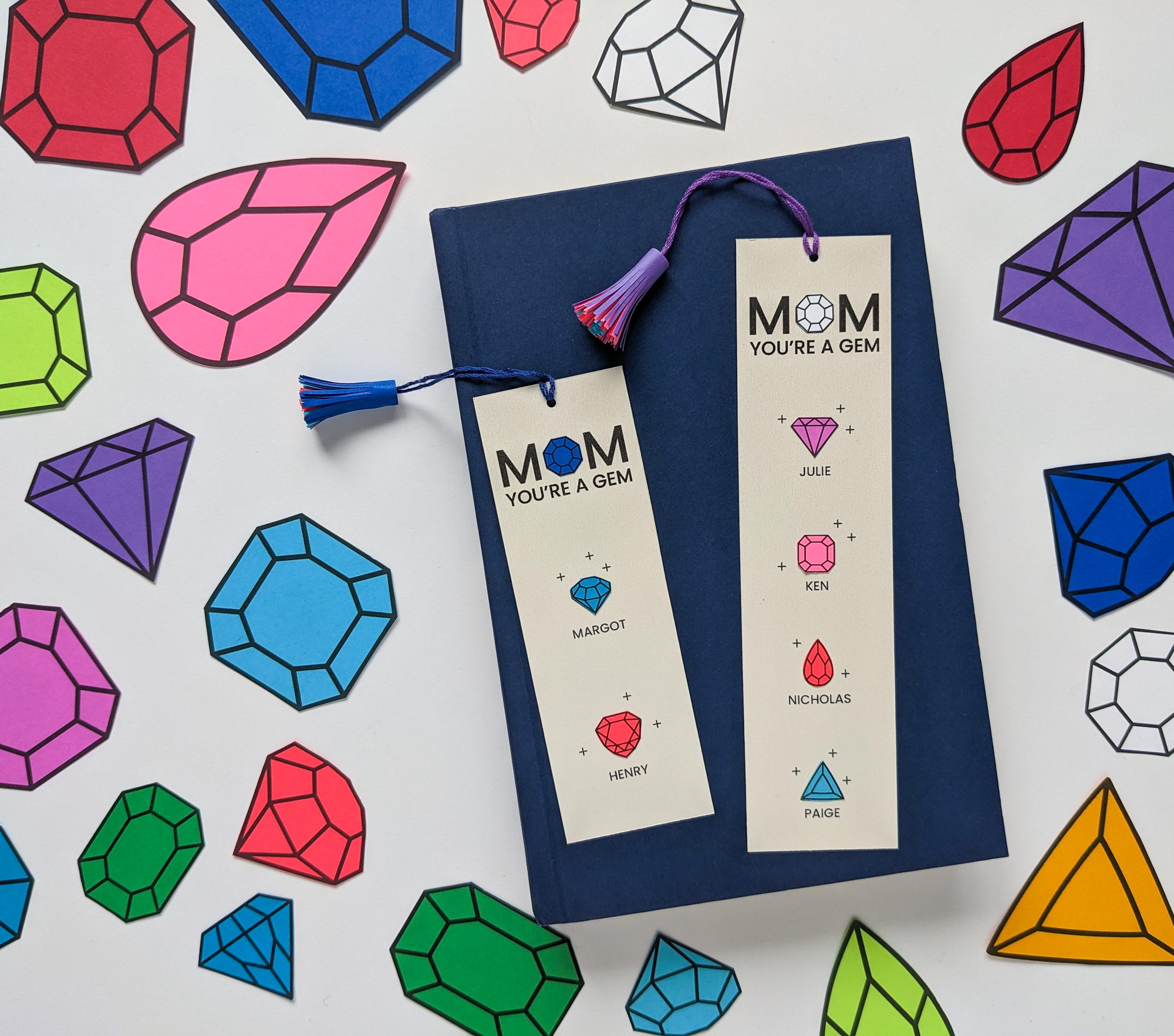 Two personalized handmade Mother's Day bookmarks featuring birthstone gems for family members