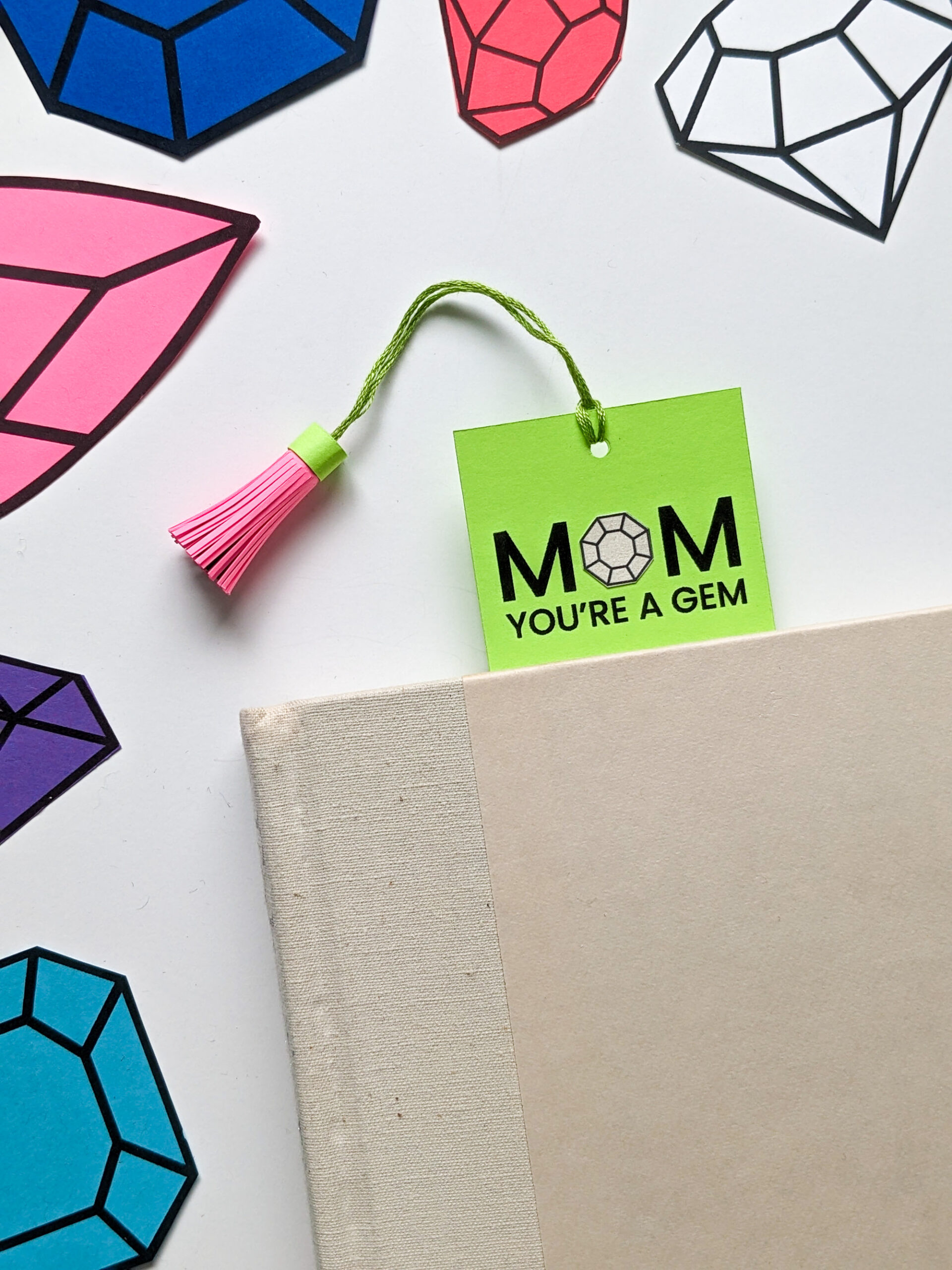 Mom You're a Gem handmade bookmark and DIY paper tassel marking a page in a book