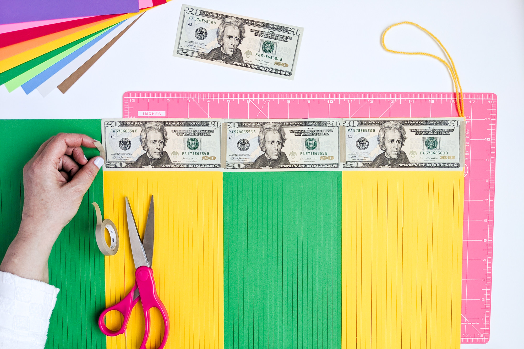 How to temporarily tape a money gift inside DIY paper graduation tassels