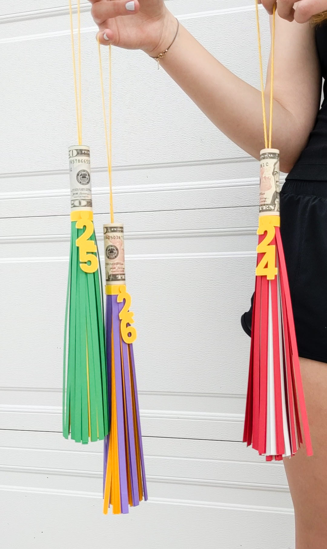 Three DIY big paper graduation tassels with money rolled inside