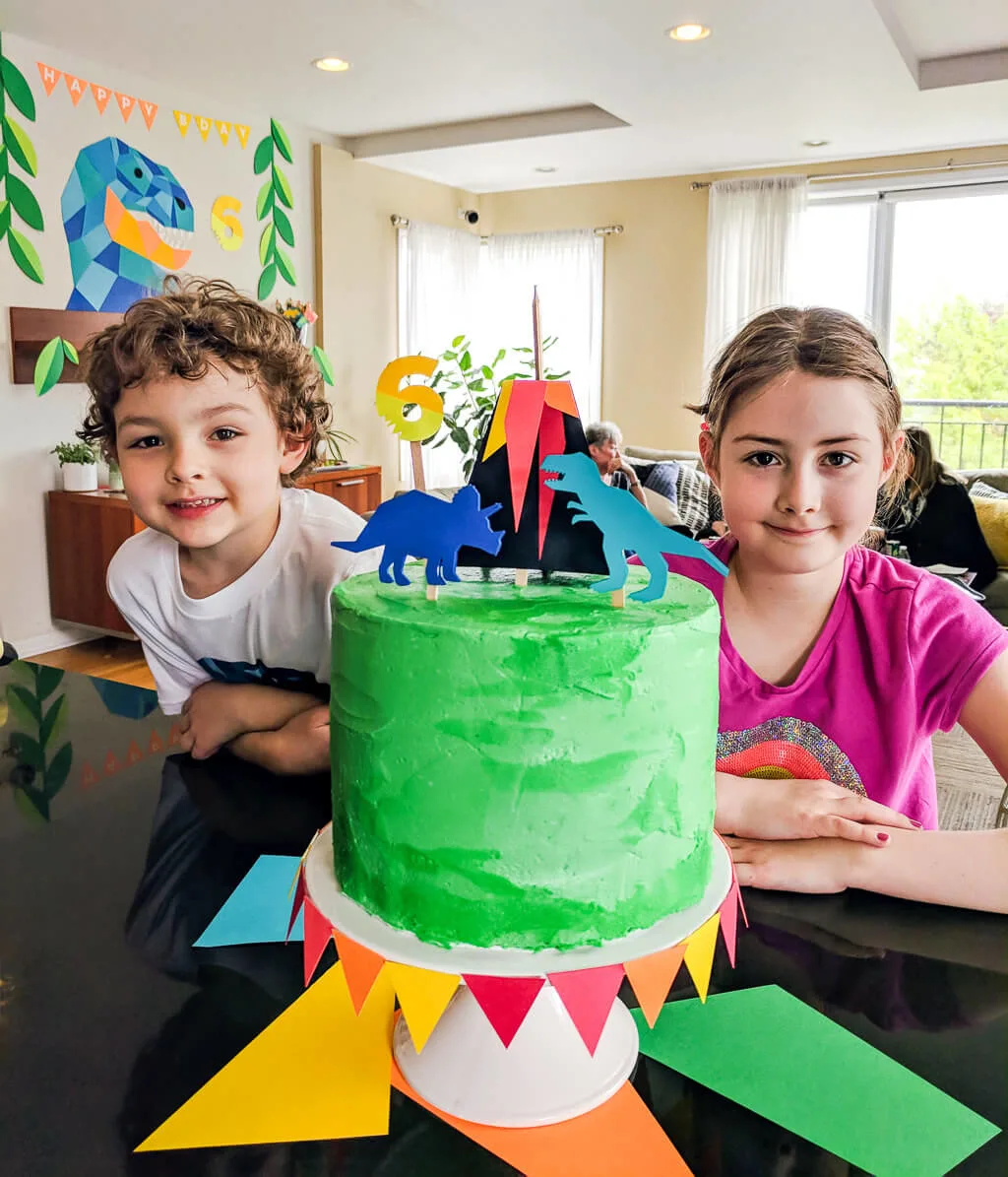 Liam and Elise with dinosaur birthday cake. Copyright Merriment Design Co. Do not use photo without written permission.