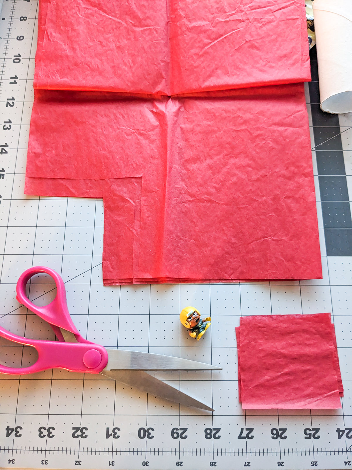 Cutting tissue paper with scissors to make a handmade advent calendar