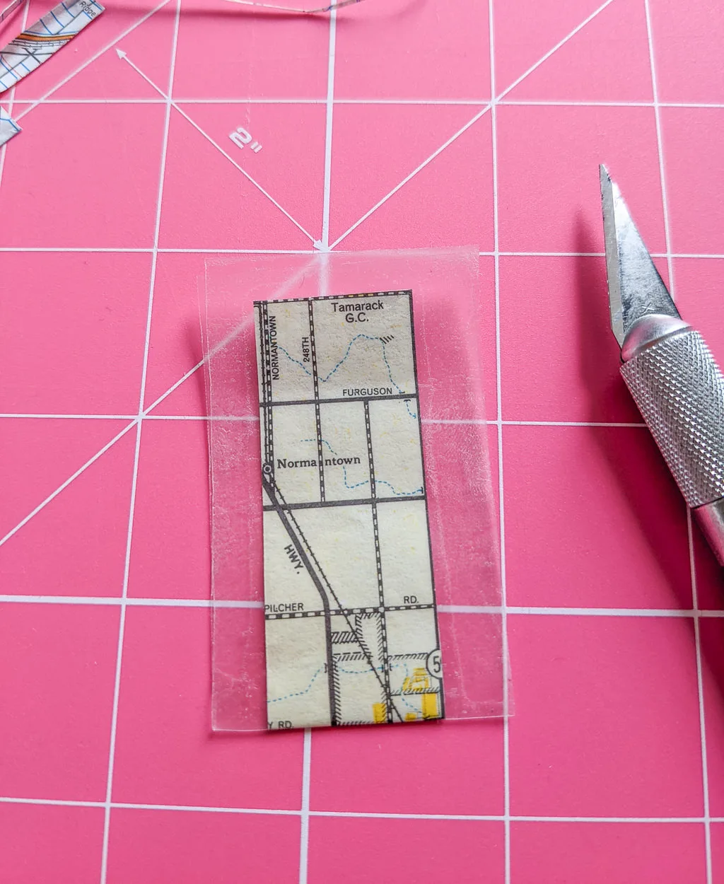 Covering paper with clear contact paper to make a card holder wallet