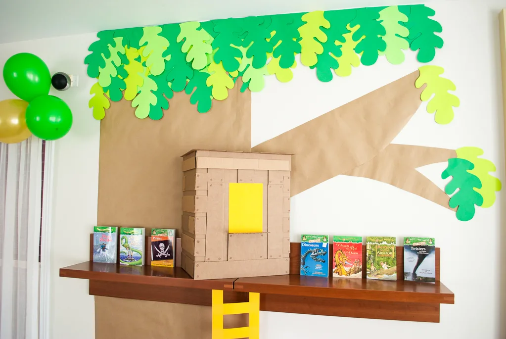 DIY Cardboard & Paper Magic Tree House Birthday Party Decoration. It's easy to recycle cardboard boxes into fun magic tree house birthday party decor for the food table.