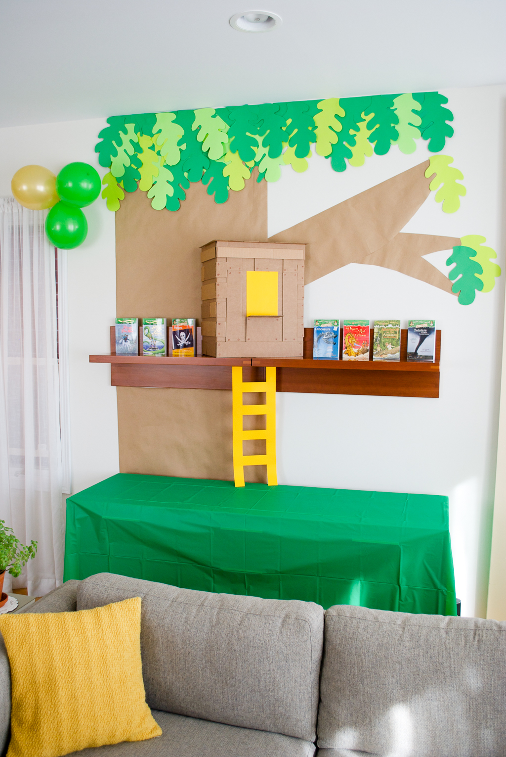 DIY Cardboard & Paper Magic Tree House Birthday Party Decoration. It's easy to recycle cardboard boxes into fun magic tree house birthday party decor for the food table.