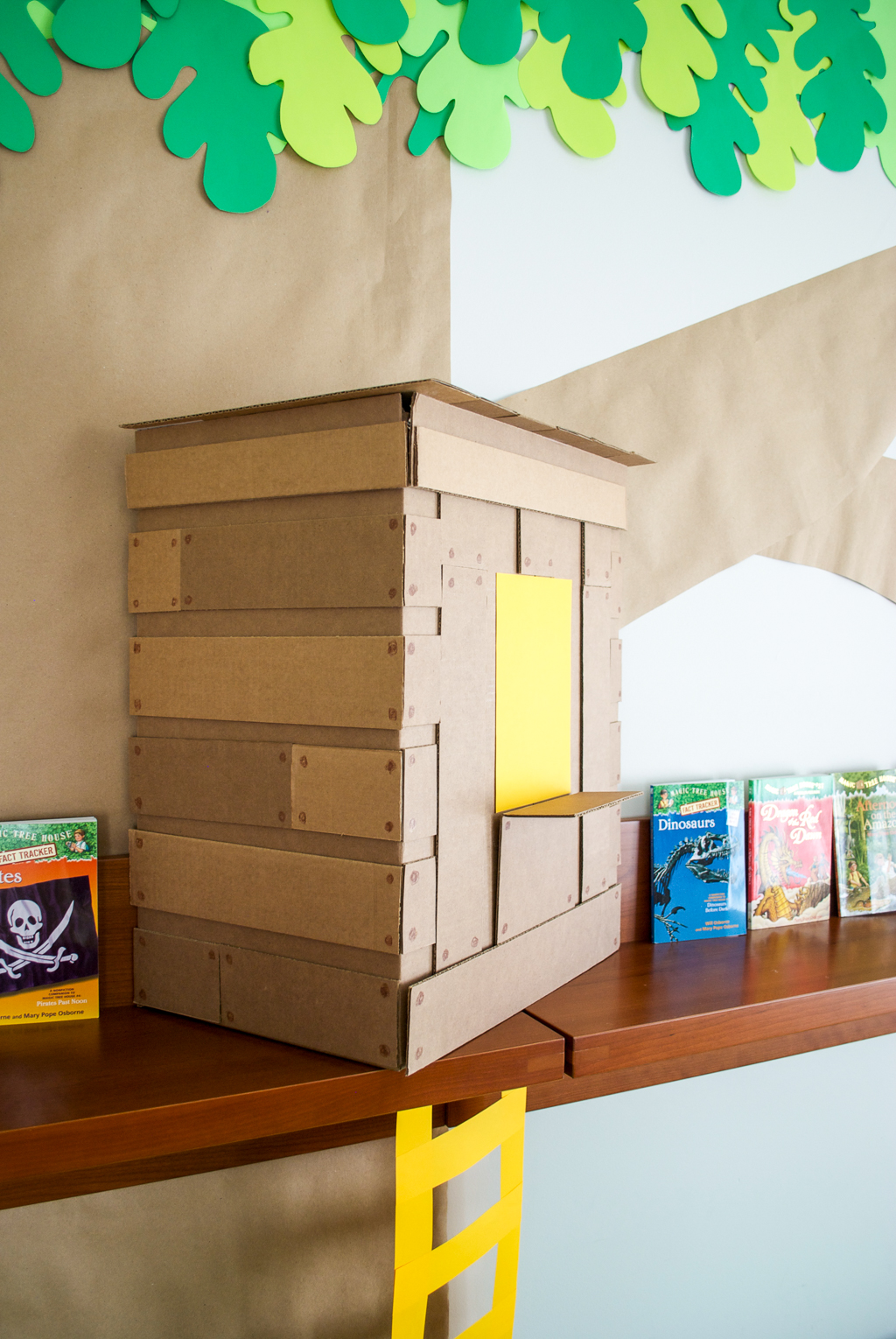 DIY Cardboard & Paper Magic Tree House Birthday Party Decoration. It's easy to recycle cardboard boxes into fun magic tree house birthday party decor for the food table.