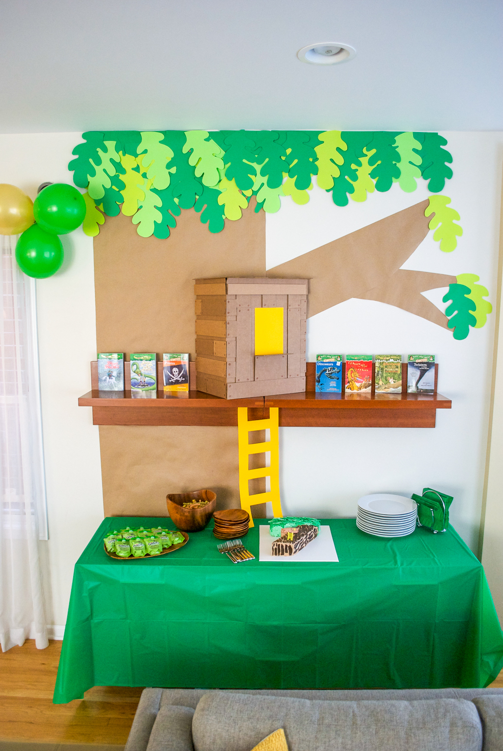 DIY Cardboard & Paper Magic Tree House Birthday Party Decoration. It's easy to recycle cardboard boxes into fun magic tree house birthday party decor for the food table.