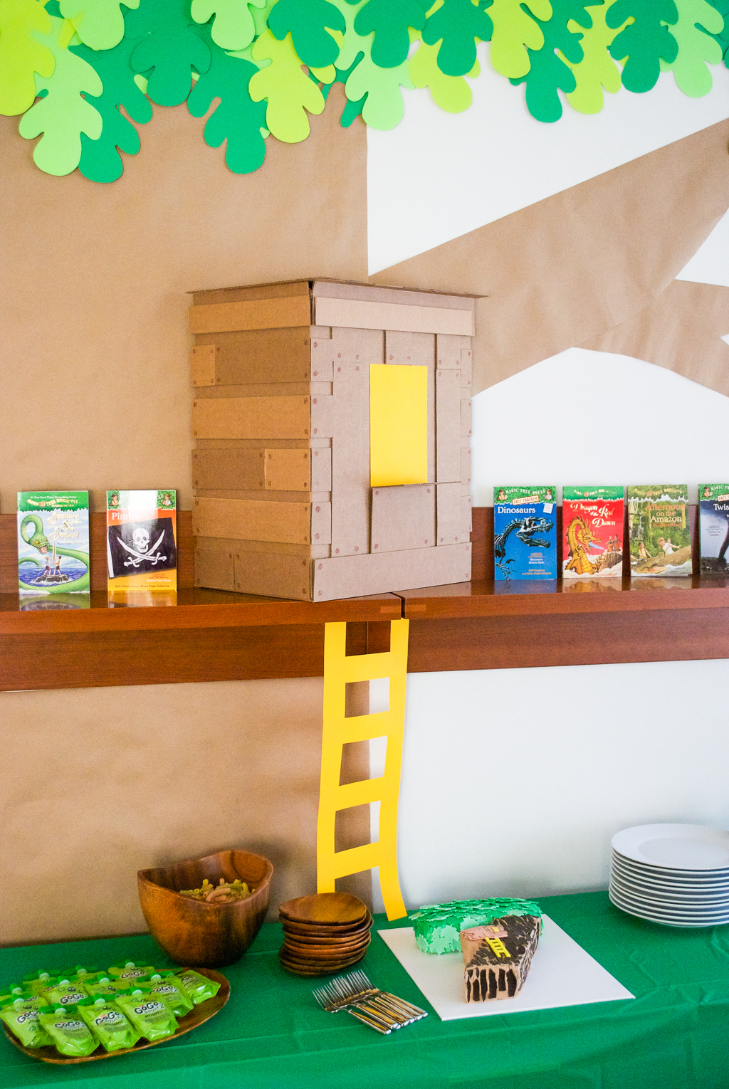 DIY Cardboard & Paper Magic Tree House Birthday Party Decoration. It's easy to recycle cardboard boxes into fun magic tree house birthday party decor for the food table.