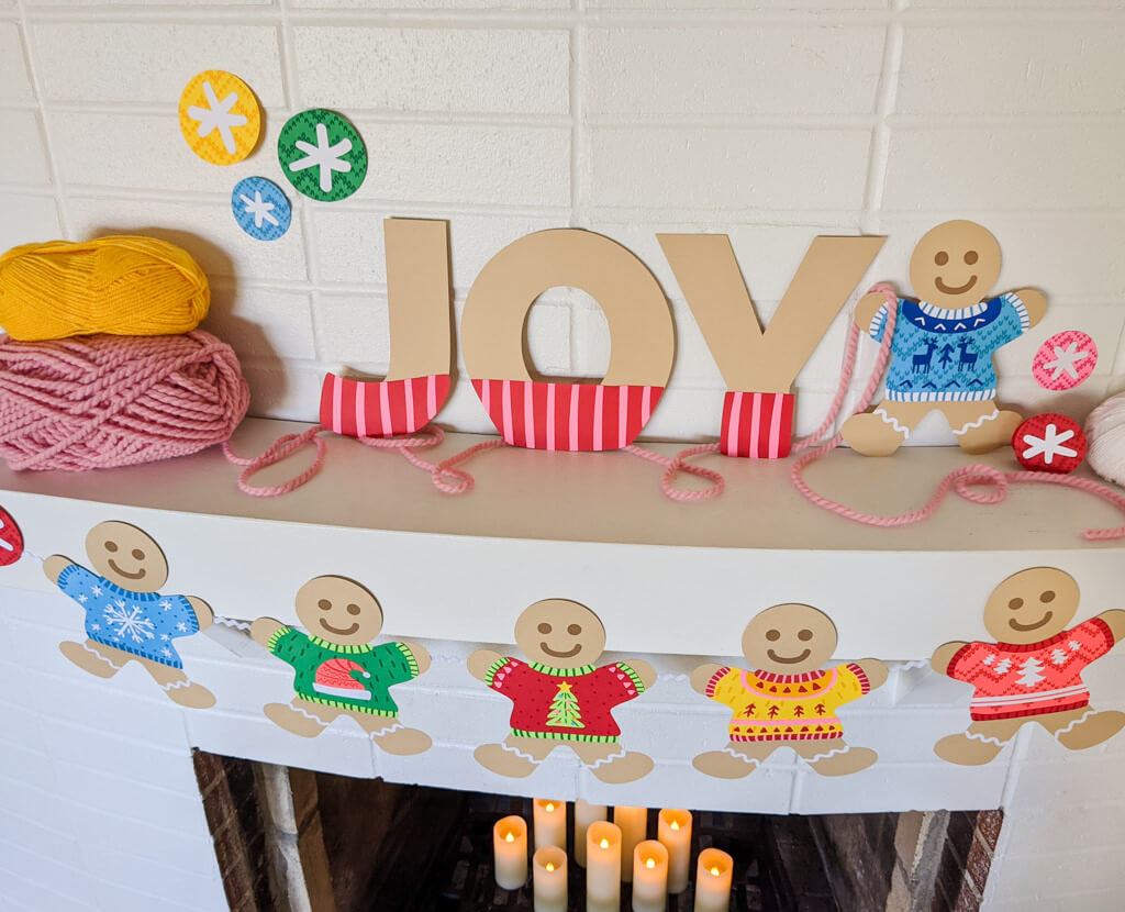 DIY Joy sign with gingerbread garland wearing ugly sweaters