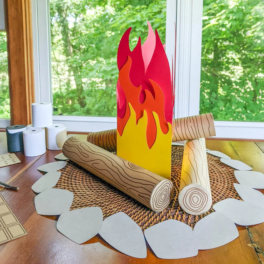 Pretend campfire with fake wood grain logs, flames, and stone safety ring
