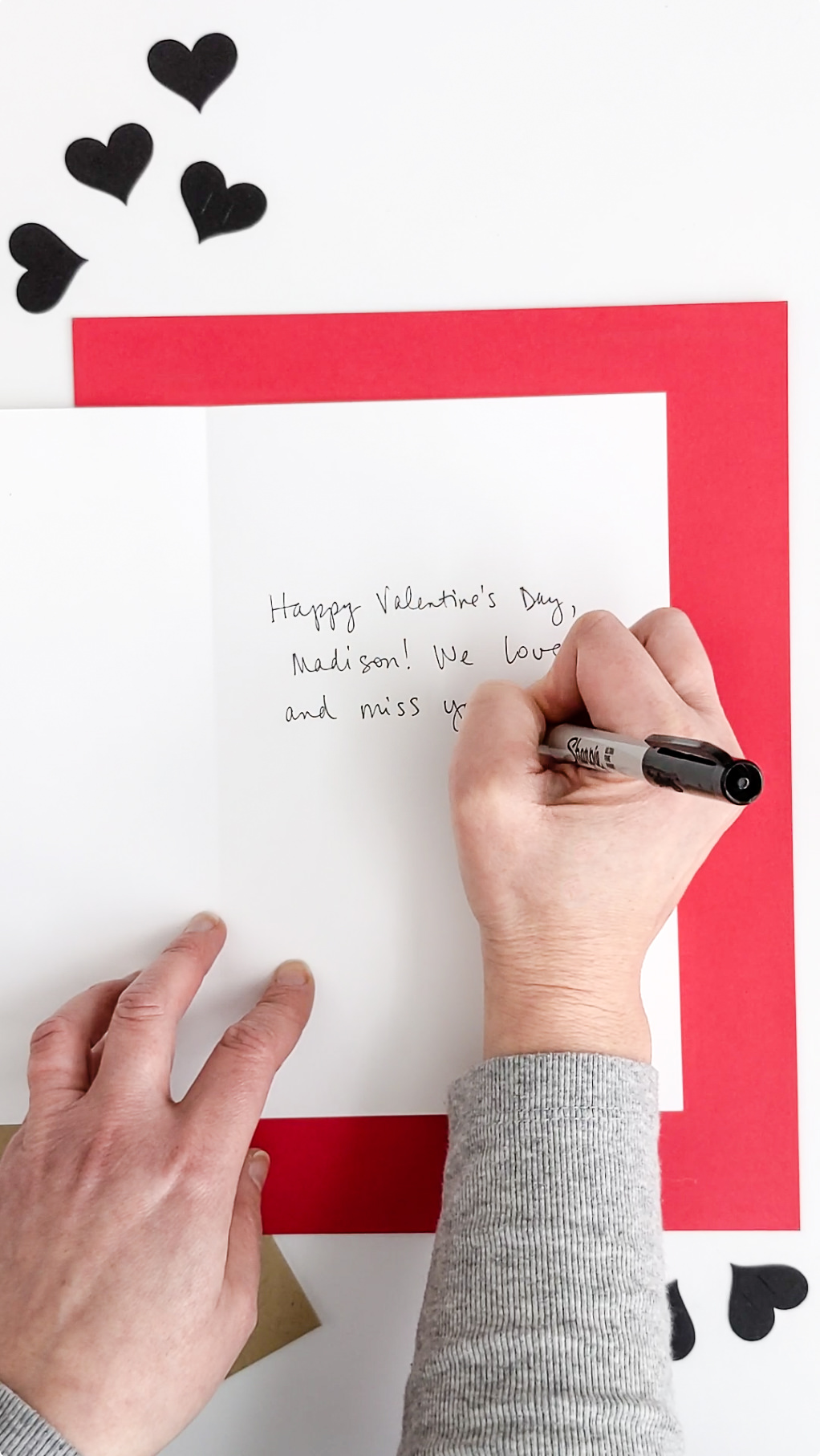 Writing inside a handmade Valentine's Day card