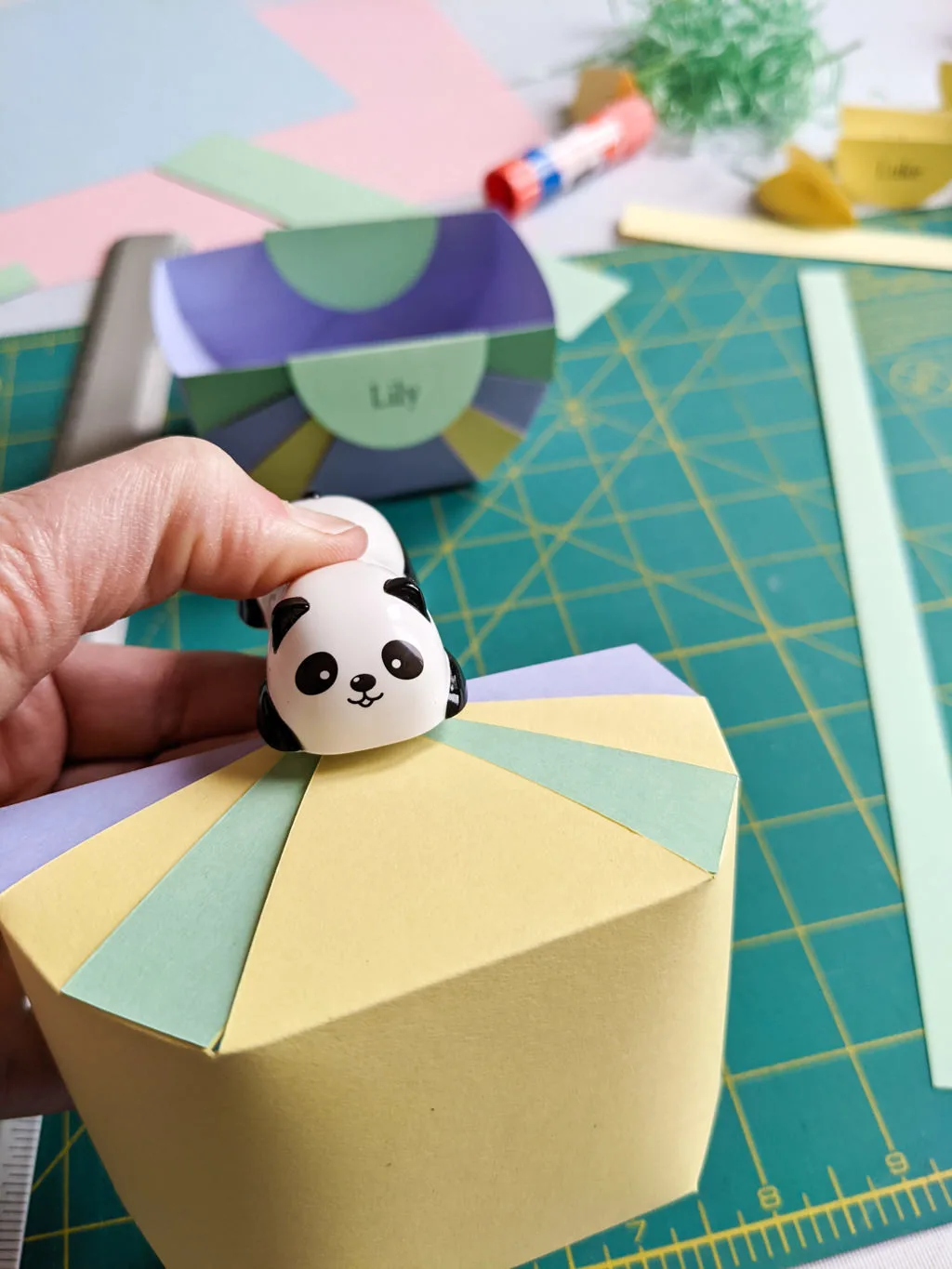 Making tiny paper Easter baskets with folded paper and a stapler