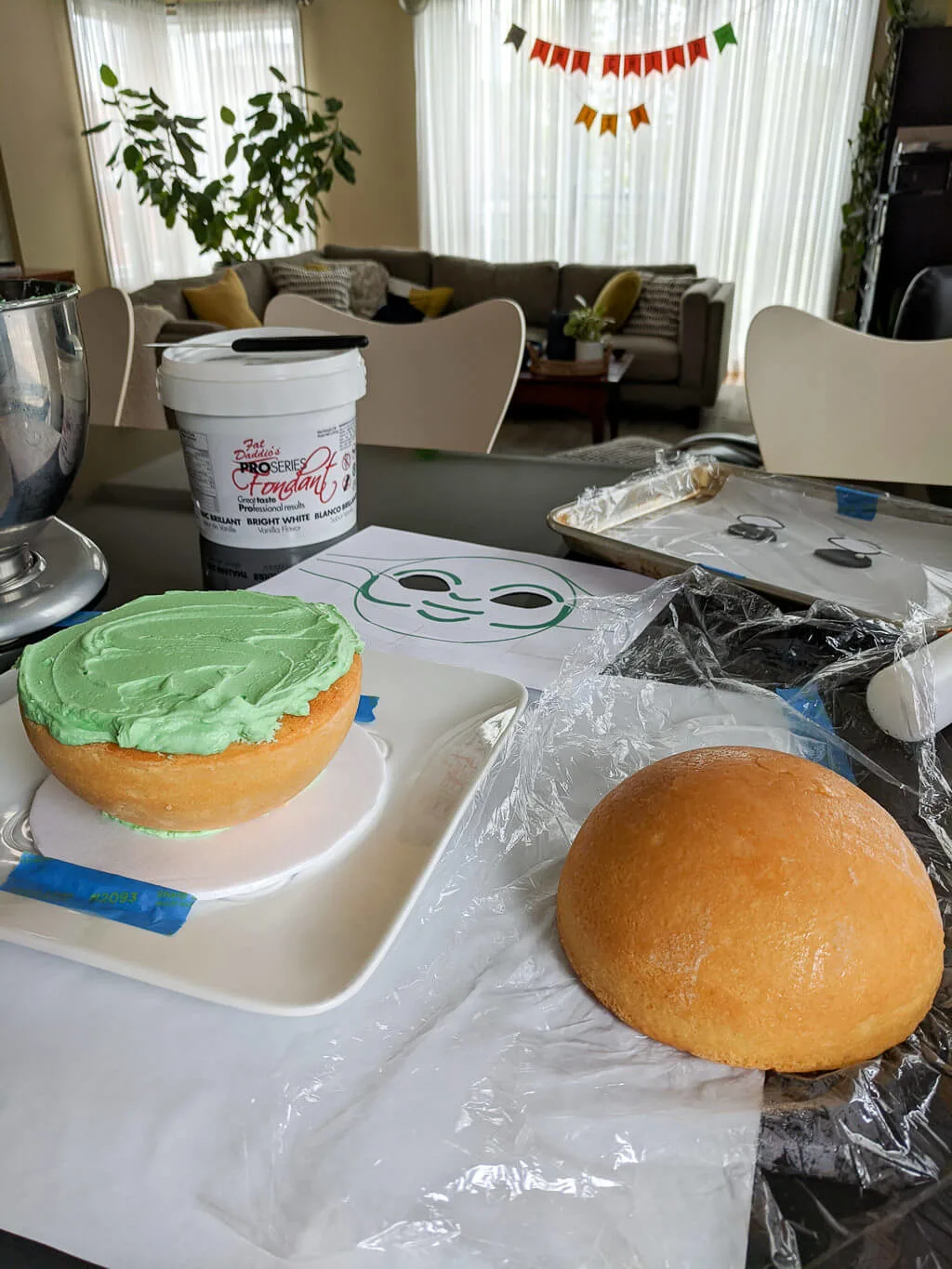 Icing buttercream between cake layers for a round ball sphere cake