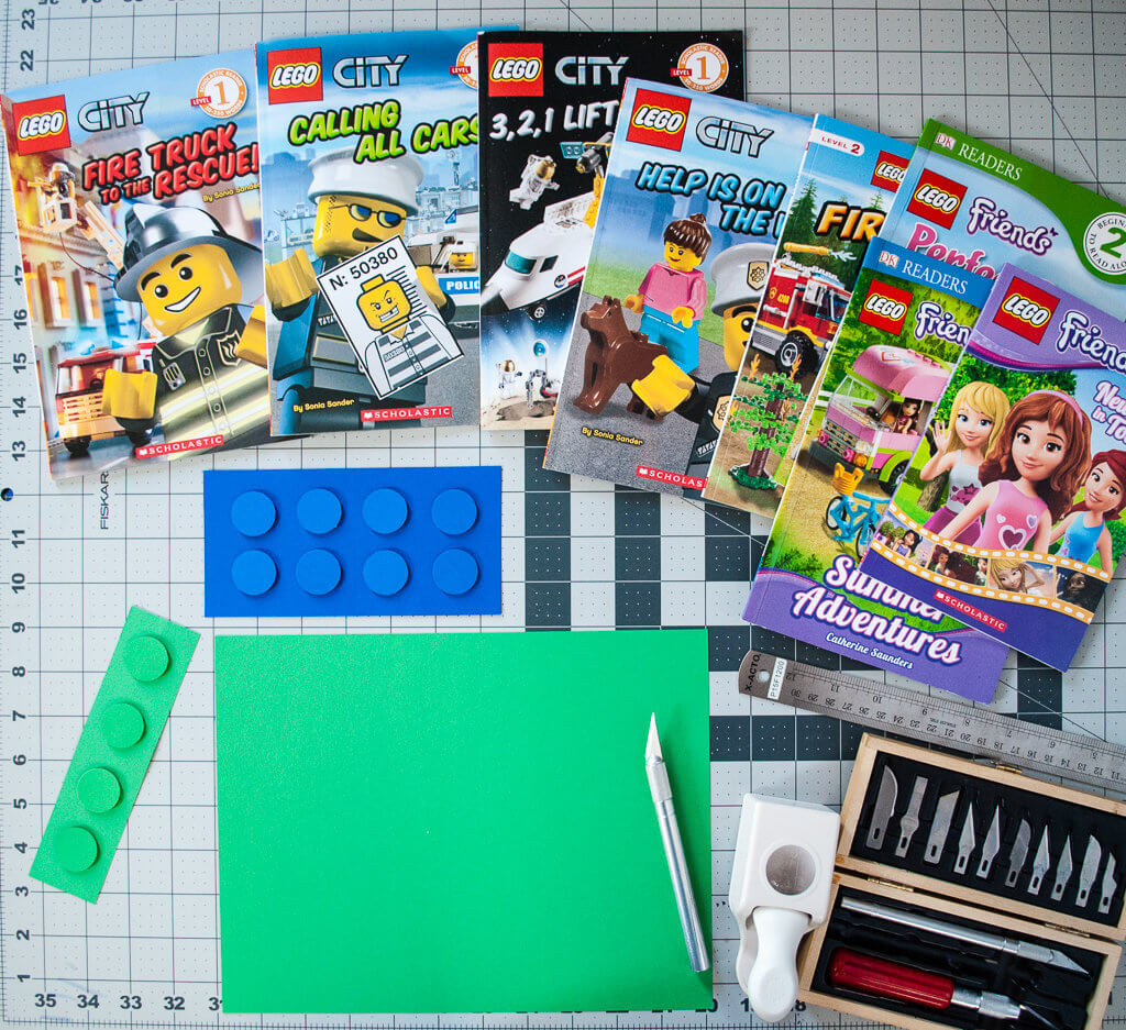 Supplies to make DIY LEGO birthday party favors using LEGO books and paper