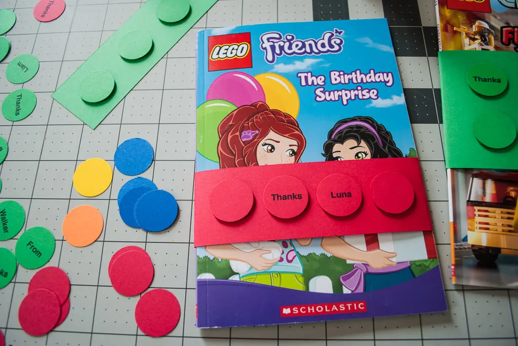 Make paper LEGO bricks to wrap books for easy LEGO birthday party favors