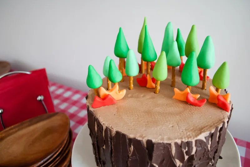 Easy DIY Planes Fire & Rescue Birthday Cake for your little fireman. This cute forest trees and flames cake is simple for beginners. Firemen Dusty, Blaze, Dipper and Windlifter are on their way to put out the forest fire in Piston Peak National Park! A trees birthday cake would be cute for a camping birthday party too.