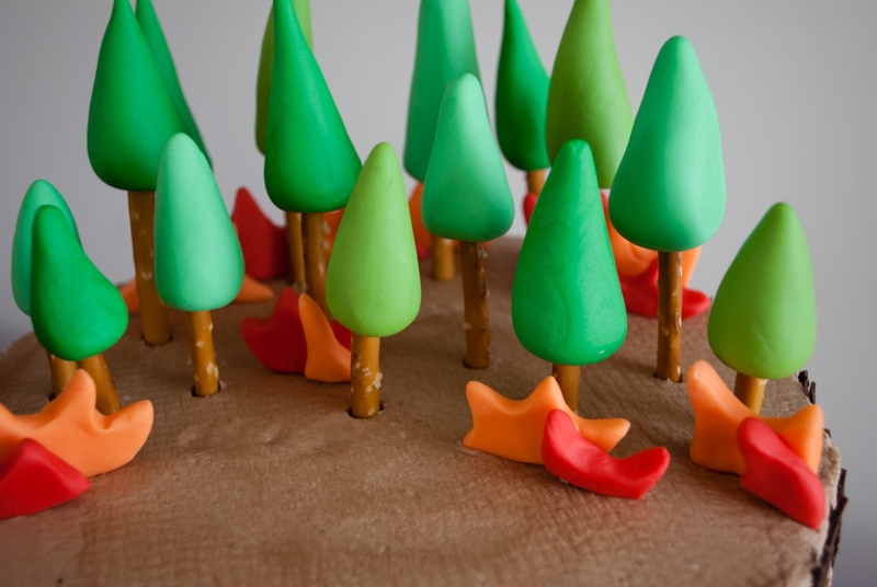 Easy DIY Planes Fire & Rescue Birthday Cake for your little fireman. This cute forest trees and flames cake is simple for beginners. Firemen Dusty, Blaze, Dipper and Windlifter are on their way to put out the forest fire in Piston Peak National Park! A trees birthday cake would be cute for a camping birthday party too.