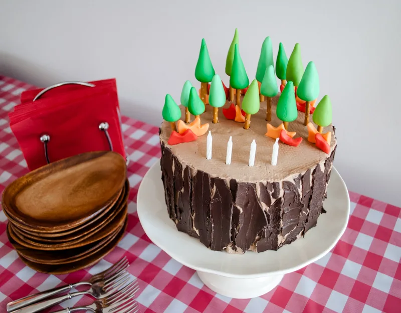 Easy DIY Planes Fire & Rescue Birthday Cake for your little fireman. This cute forest trees and flames cake is simple for beginners. Firemen Dusty, Blaze, Dipper and Windlifter are on their way to put out the forest fire in Piston Peak National Park! A trees birthday cake would be cute for a camping birthday party too.