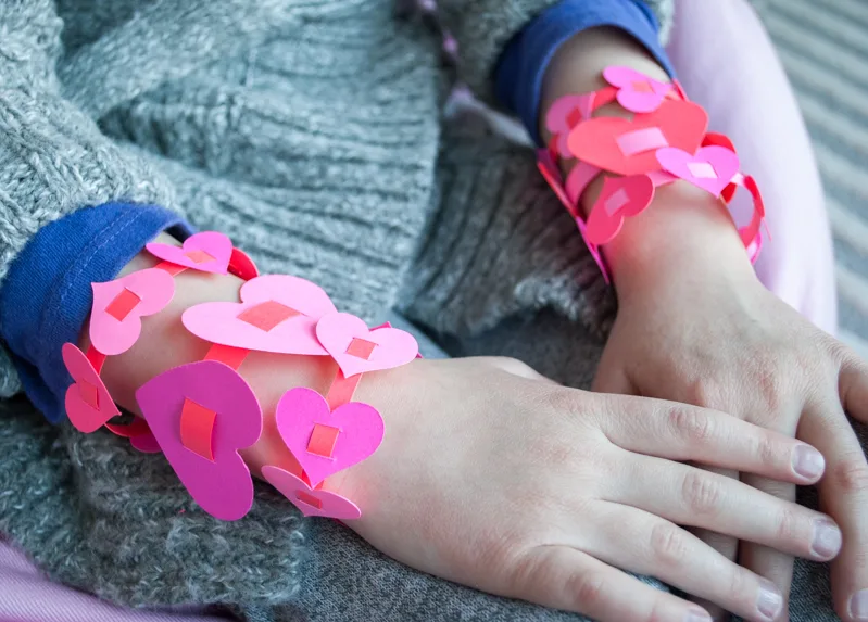 Easy DIY Valentine’s Day Paper Heart Bracelets for Kids. Make these cute and easy Valentine's Day heart bracelets with your kids this Valentine's Day!