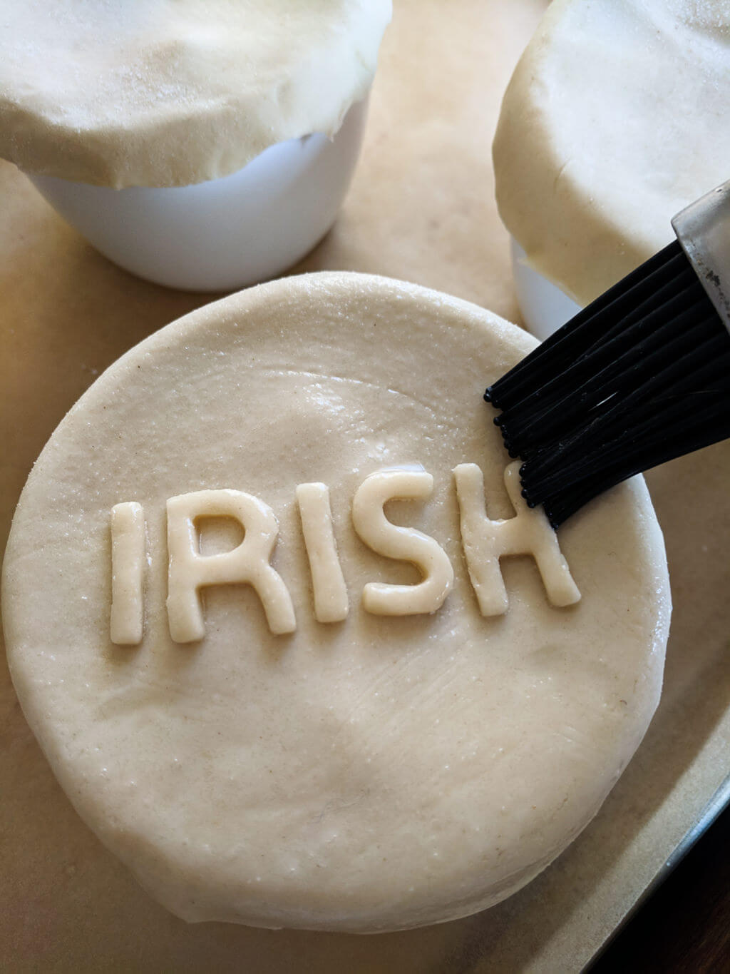 Brushing pie dough with egg wash