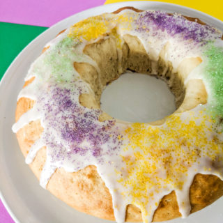 King cake iced with purple, green, and yellow sprinkles