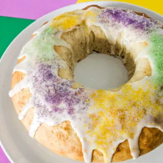 King cake iced with purple, green, and yellow sprinkles