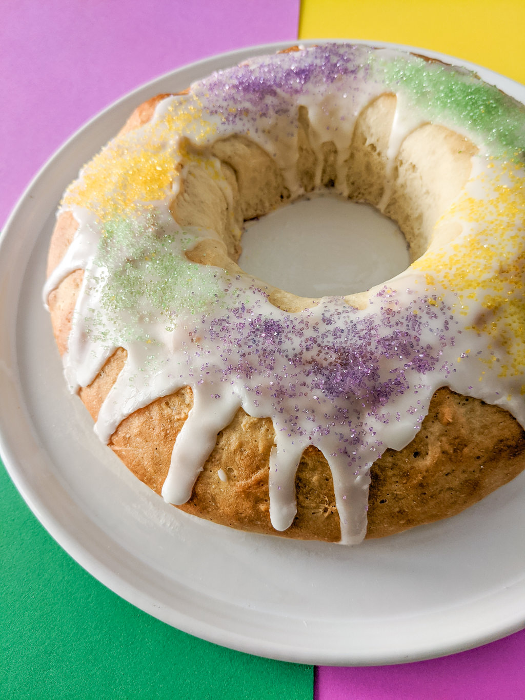 King Cake with green, yellow, and purple decorations Mardi Gras