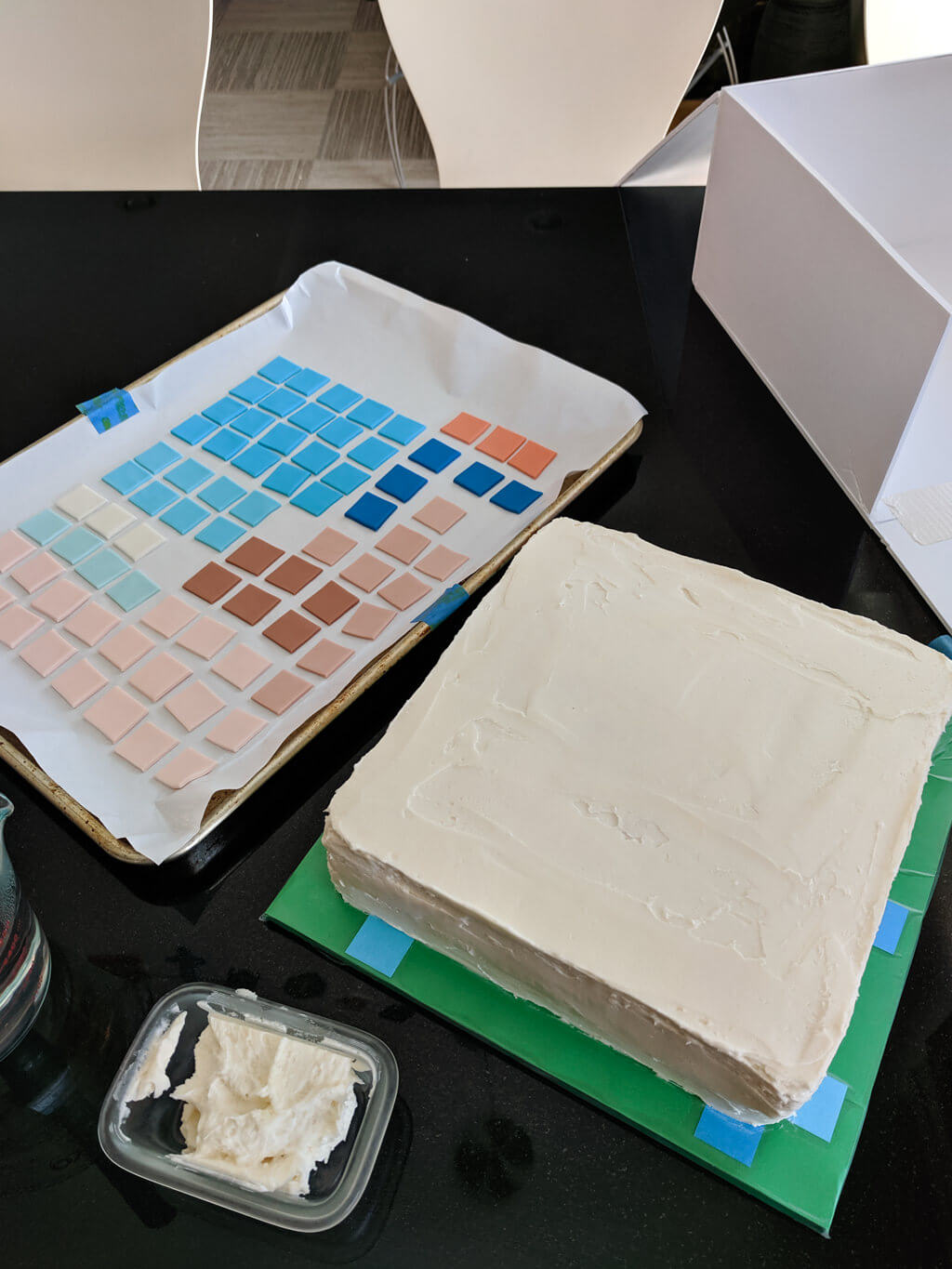 Buttercream on a square Minecraft cake ready for fondant