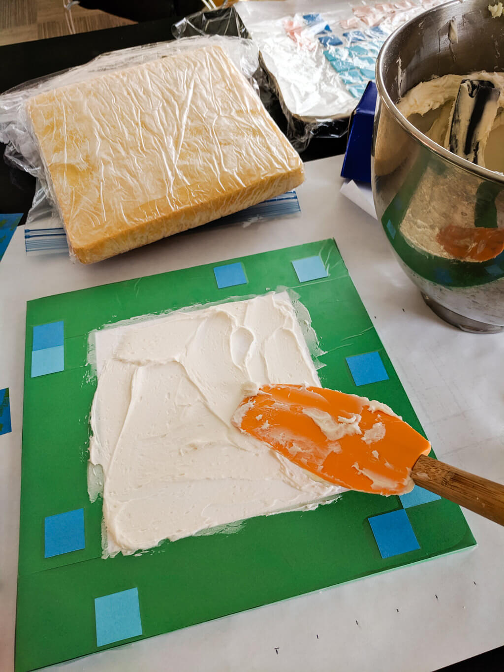Putting buttercream icing on a Minecraft cake board