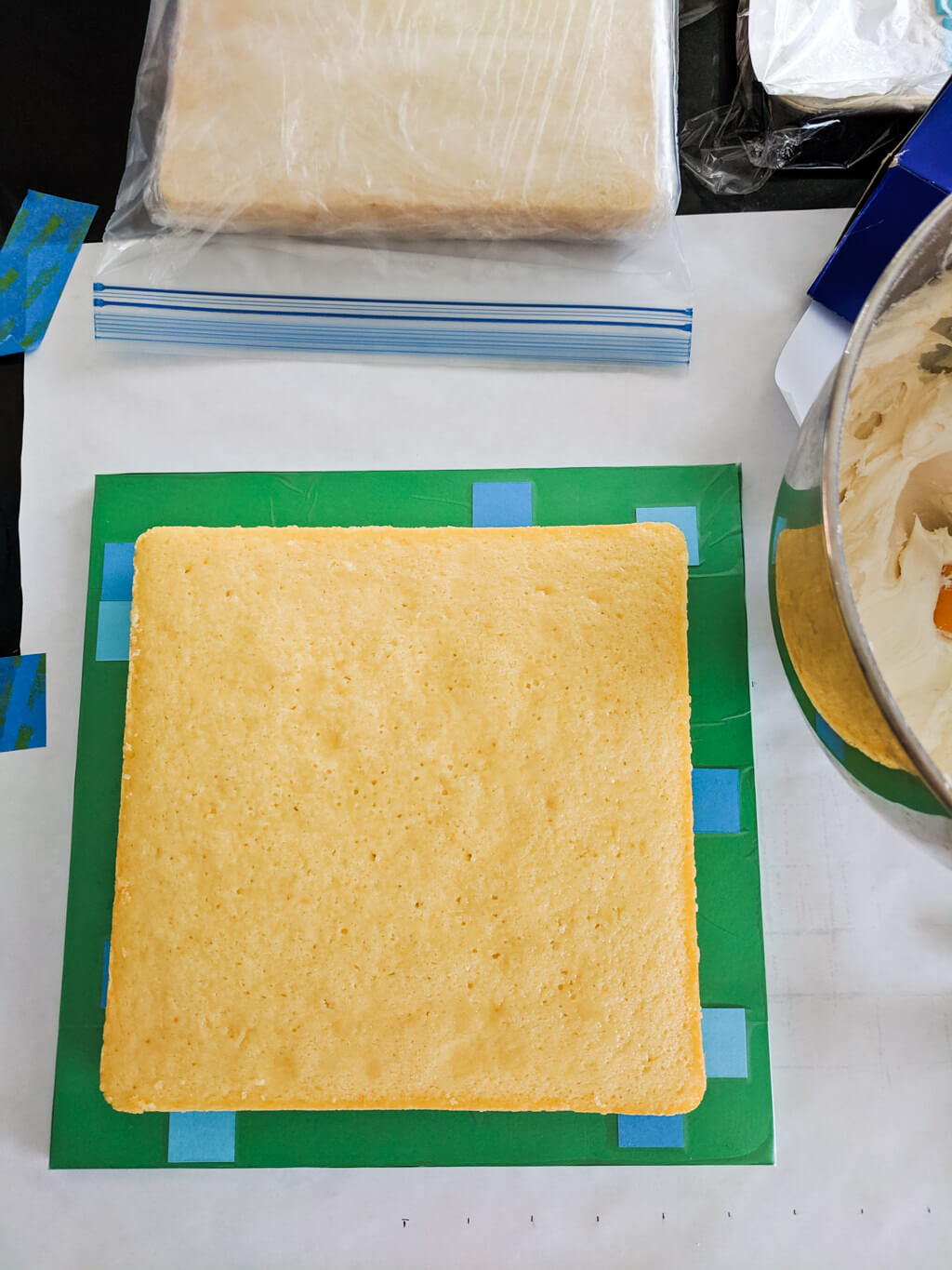 Square cake on a Minecraft cake board ready for icing
