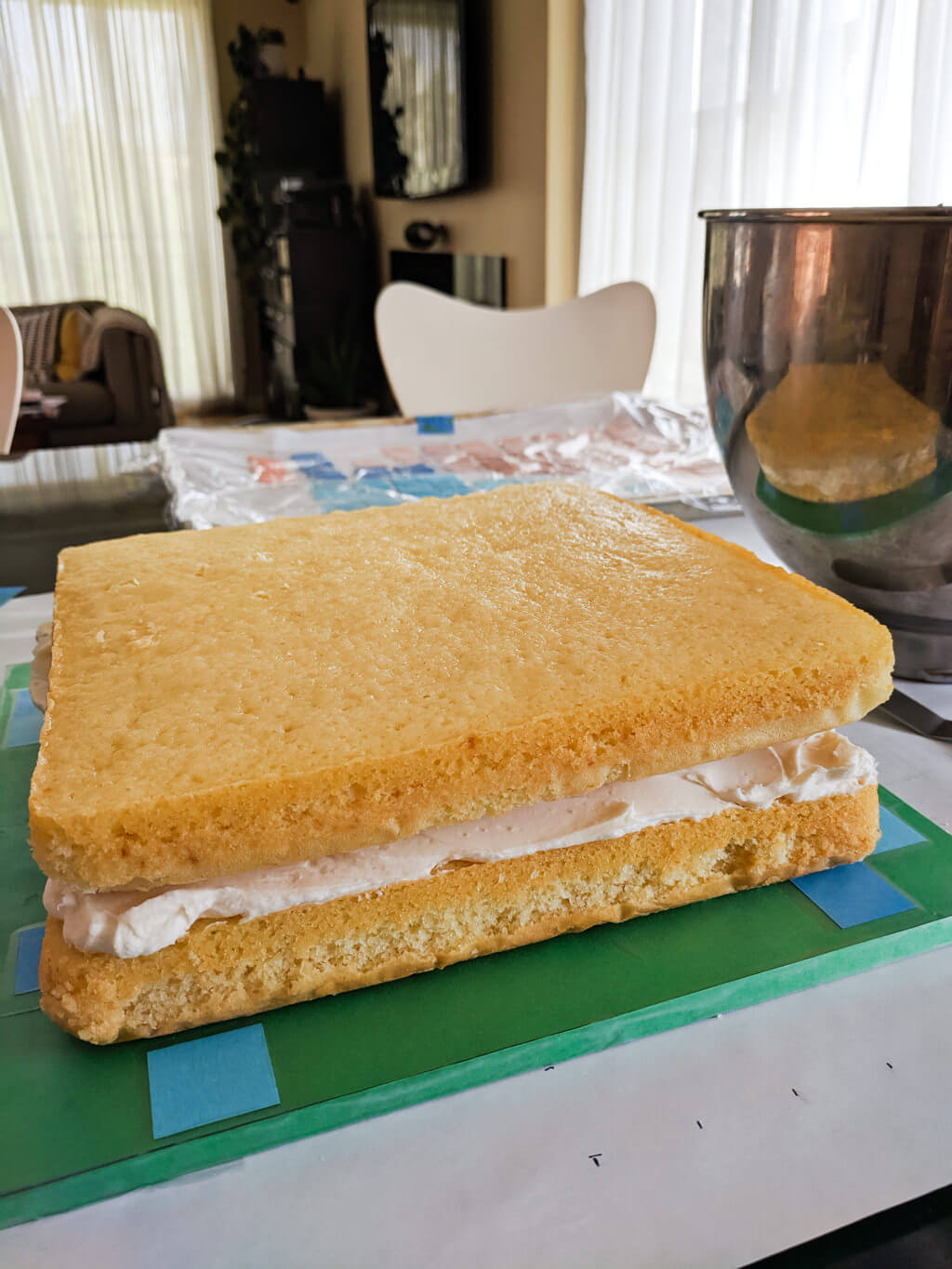 Square cake on a Minecraft cake board ready for icing