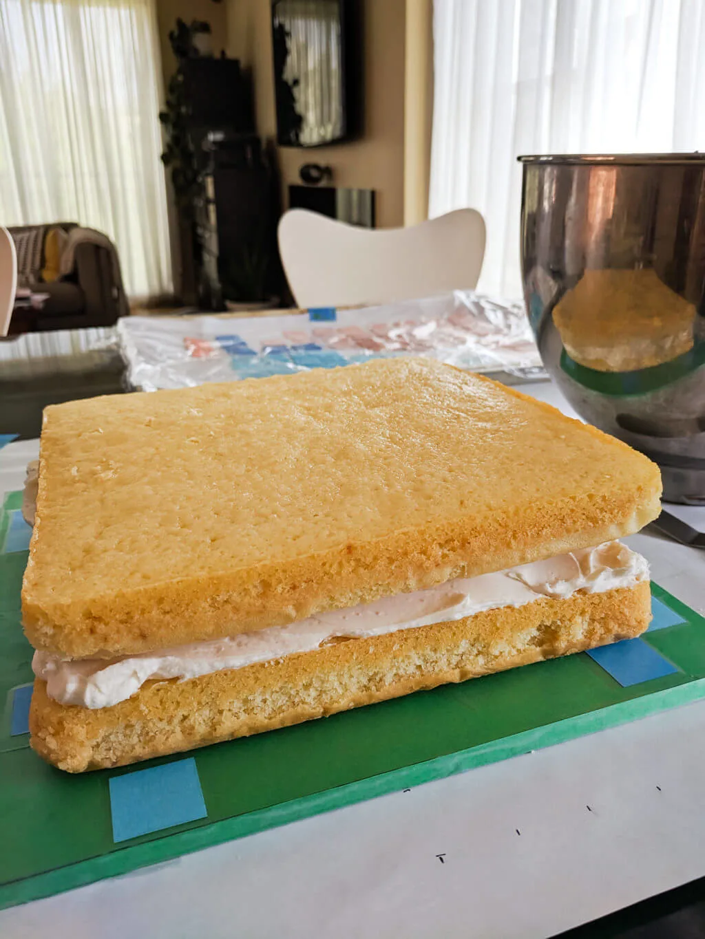 Square cake on a Minecraft cake board ready for icing