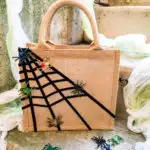 Easy no-sew DIY Halloween treat bag for kids with sticky spiderwebs and moving spiders ...eek!