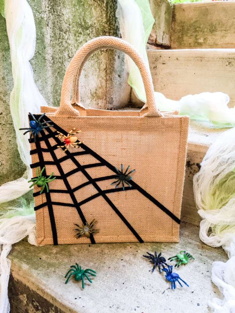 Easy no-sew DIY Halloween treat bag for kids with sticky spiderwebs and moving spiders ...eek!