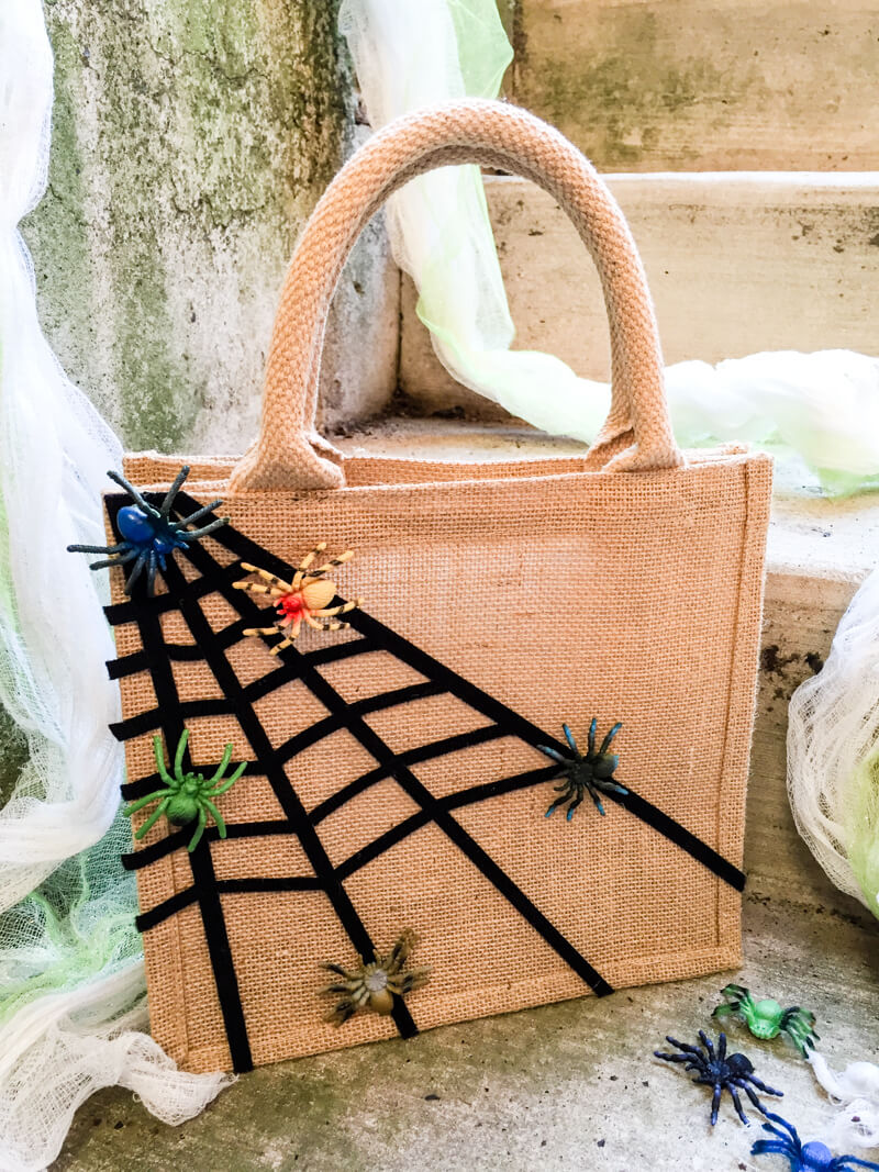 Easy no-sew DIY Halloween treat bag for kids with sticky spiderwebs and moving spiders ...eek!