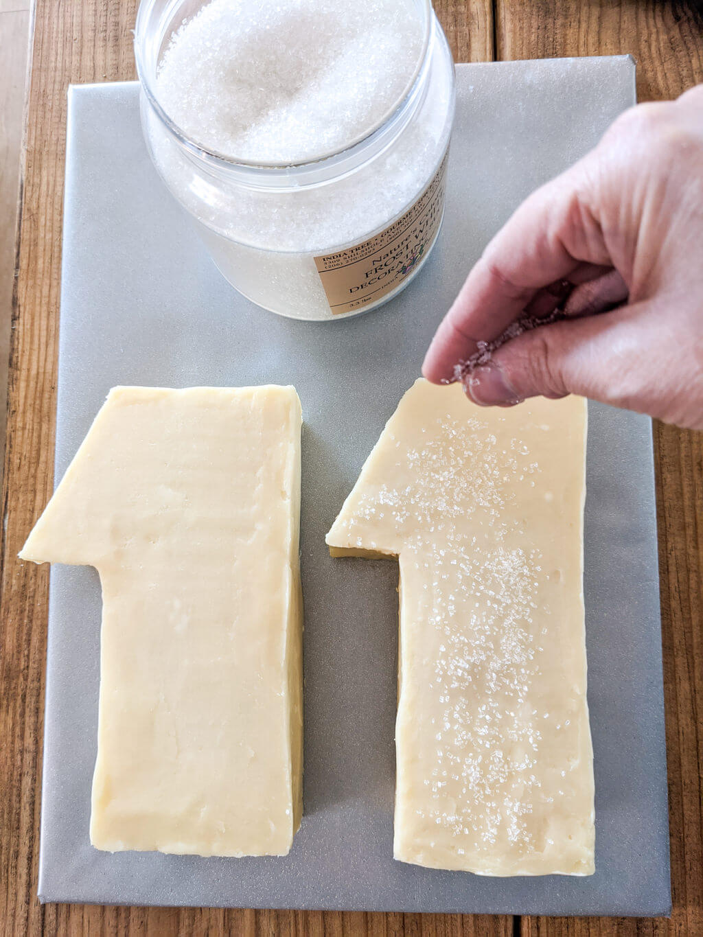 Decorating an age 11 cake with sanding sugar