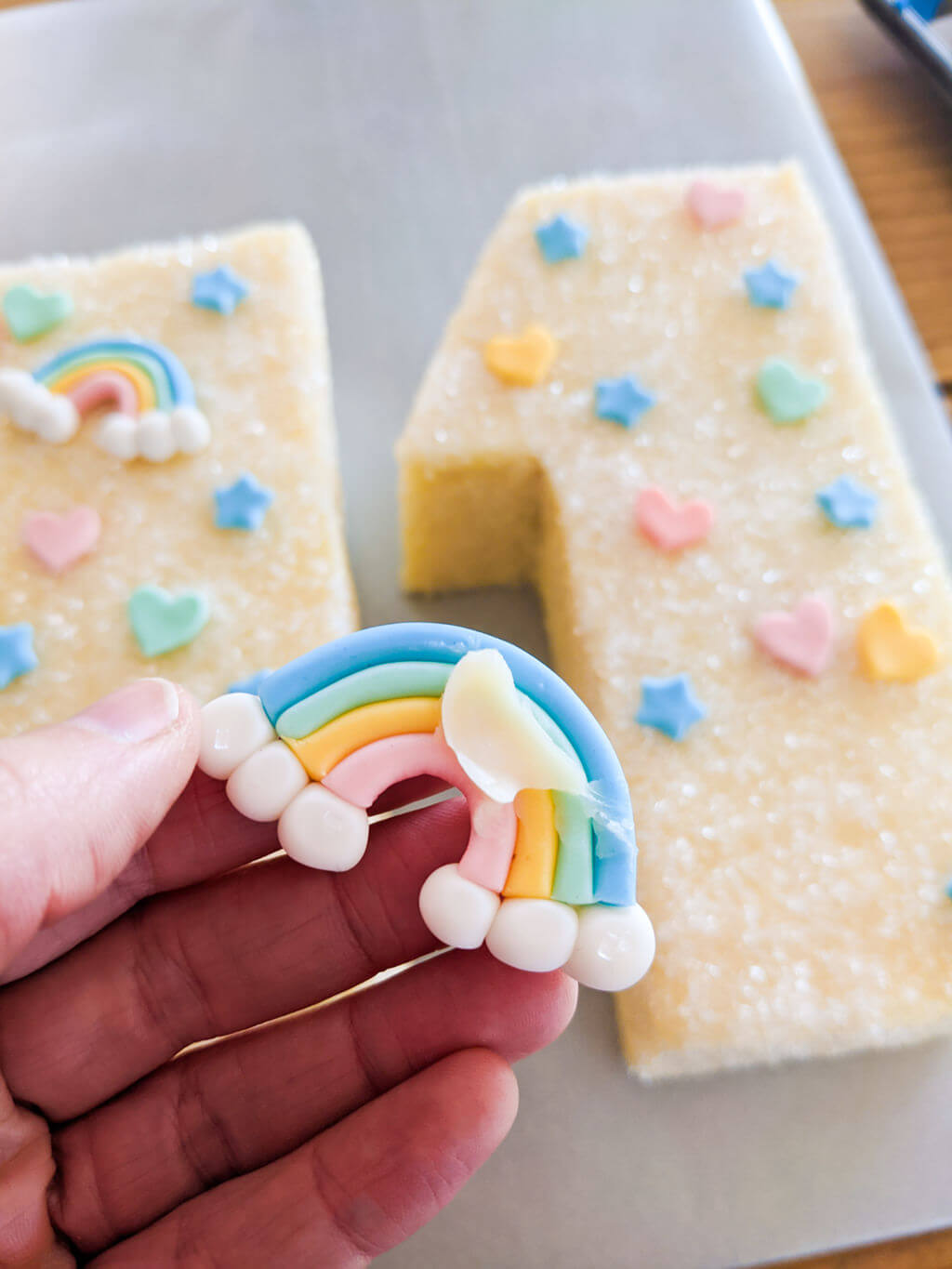 How to stick fondant rainbows onto a cake