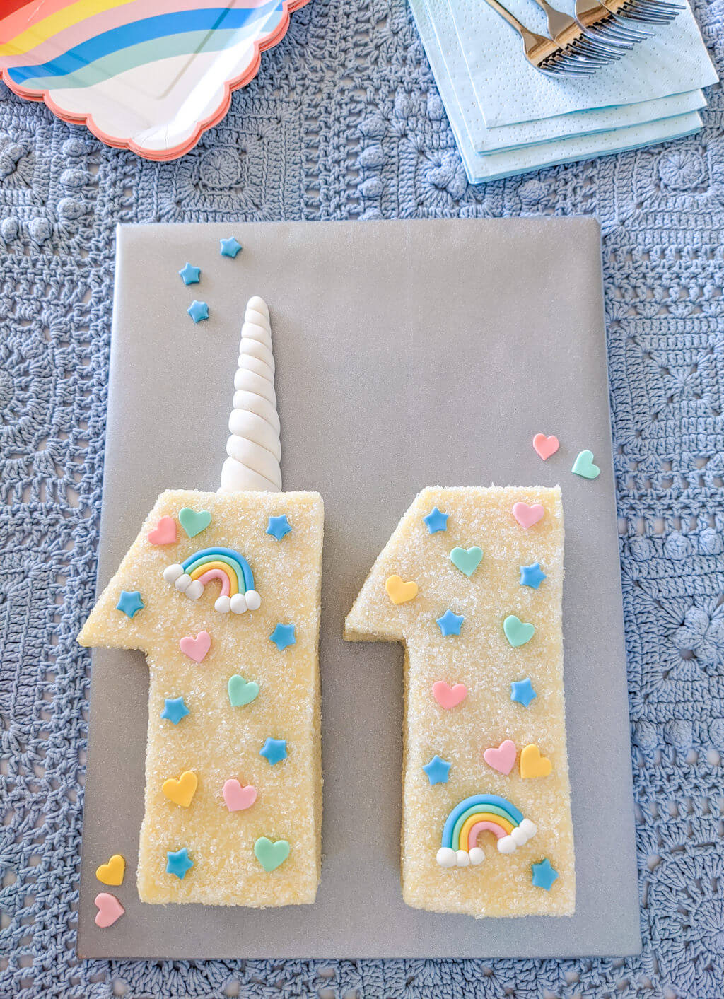 Tween unicorn birthday cake with fondant horn, rainbows, stars, and hearts