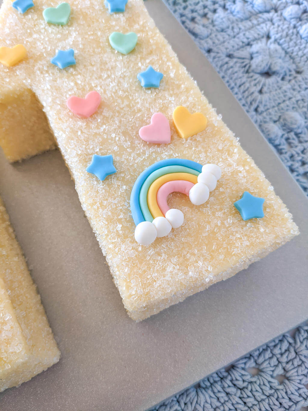 Birthday cake with fondant rainbow, hearts, and stars