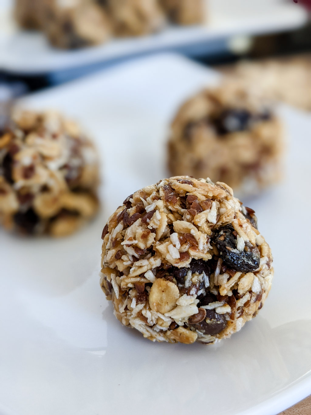 No-bake energy balls recipe with oatmeal, coconut, raisins, chocolate chips, honey