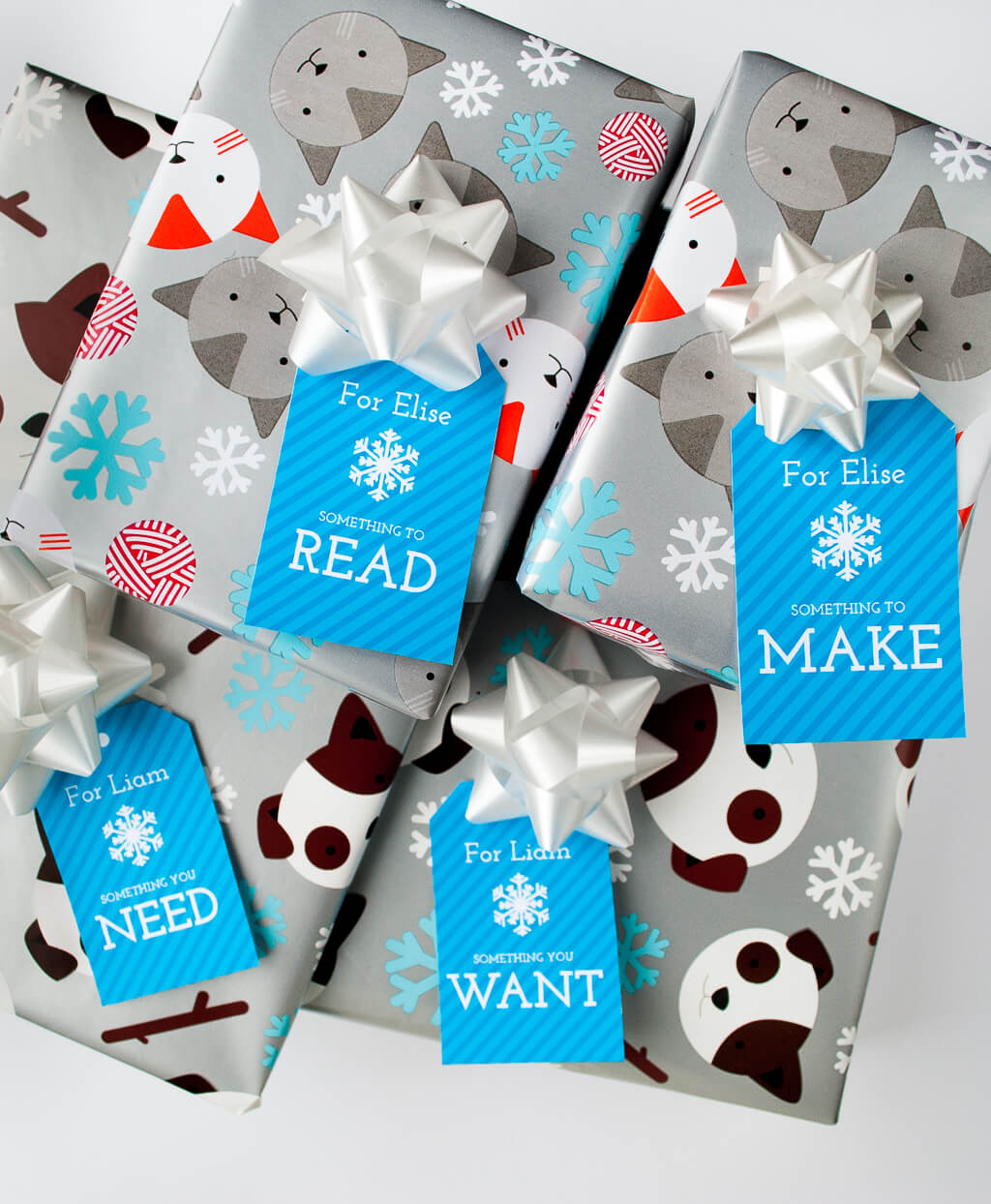 Free printable Four Gift Christmas gift tags in blue. It's changed our holidays for the better to give just four thoughtful Christmas gifts to each kid: Want, Need, Make, Read. Download the free printable Christmas gift tags, type to personalize, and print! #christmas #christmasgifts #giftwrapping #gifttags #freeprintable #printable