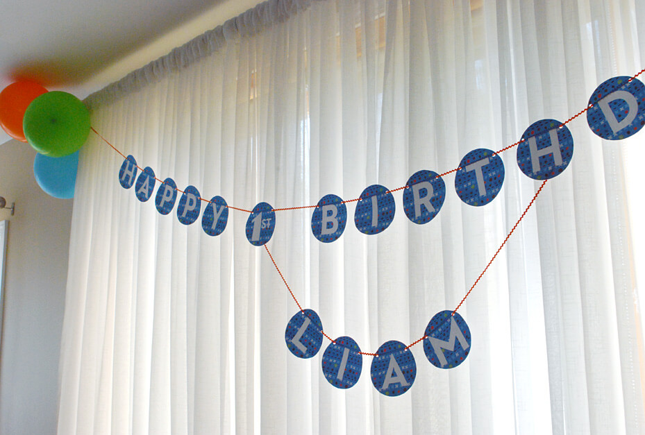 1st birthday banner in blue hung for a party