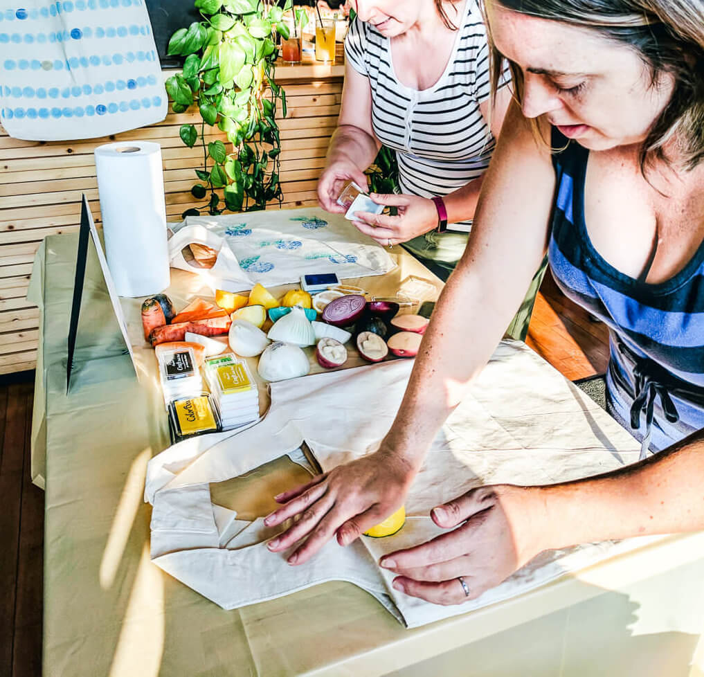 Making DIY reusable grocery bags using veggie stamping and fruit stamping - it's an easy and fun craft activity for a party!